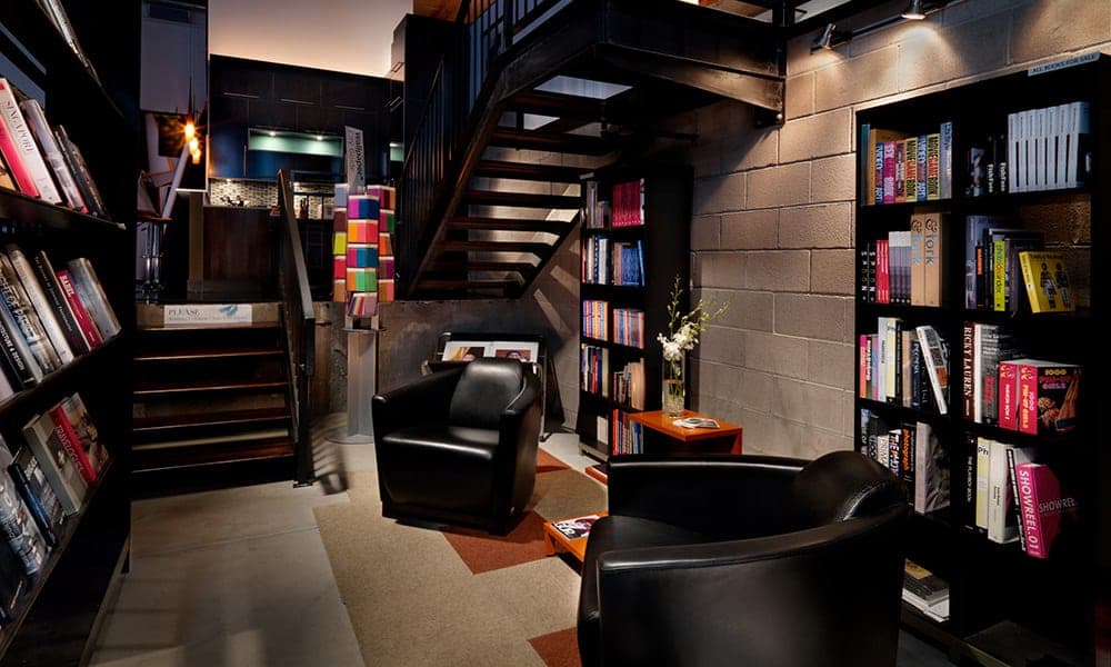 The entry library with teak stairs and editorial reference shelves